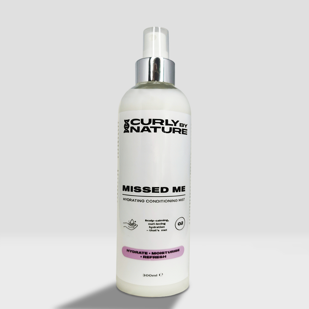 A conditioning spray bottle with 'Curly by Nature MISSED ME Hydrating Conditioning Hair' for afro and curly hair