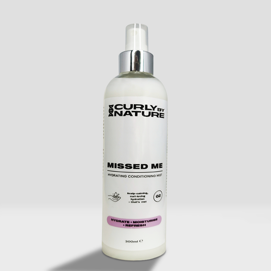 A conditioning spray bottle with 'Curly by Nature MISSED ME Hydrating Conditioning Hair' for afro and curly hair