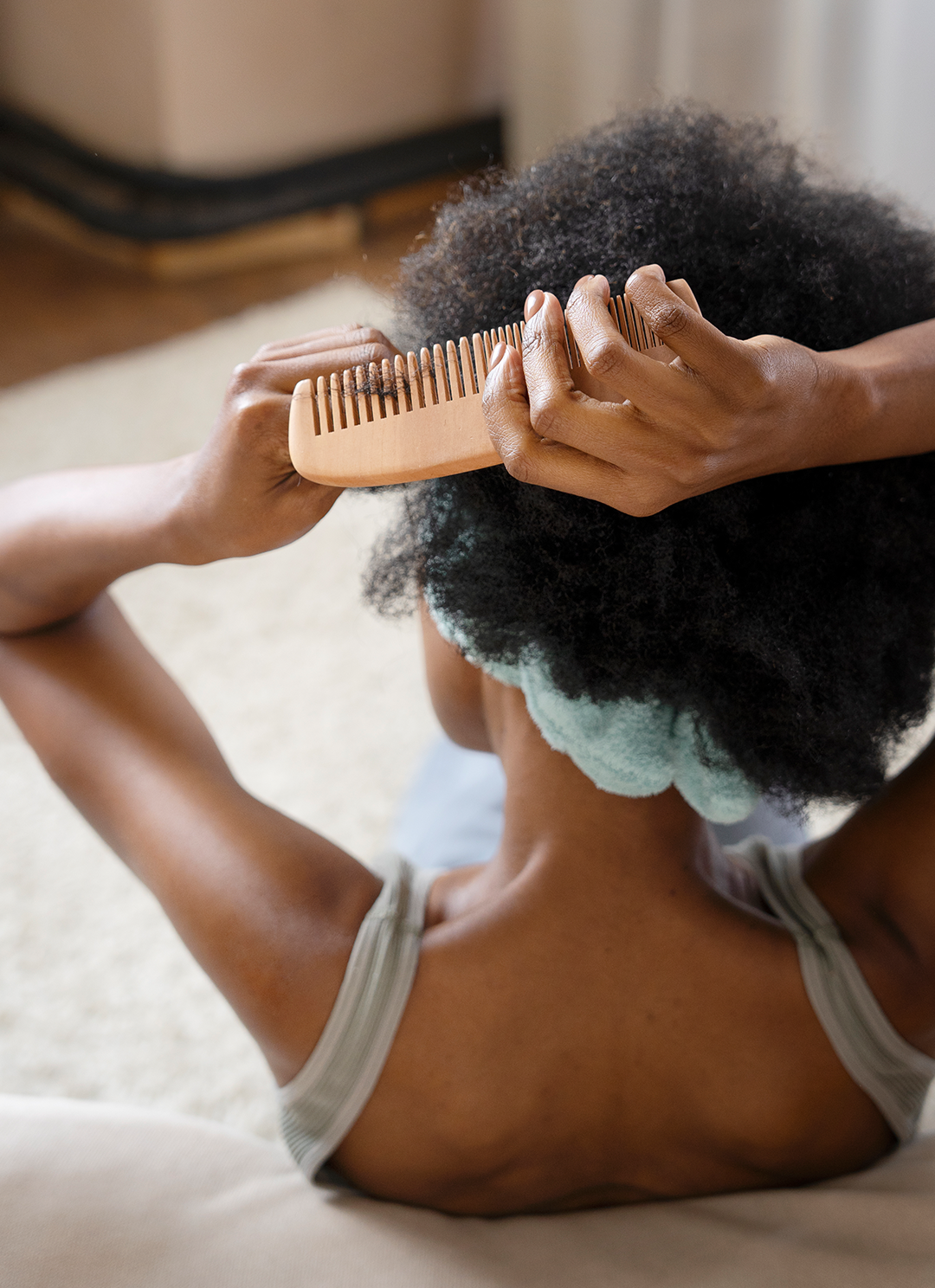 Afro hair black girl combing hair top