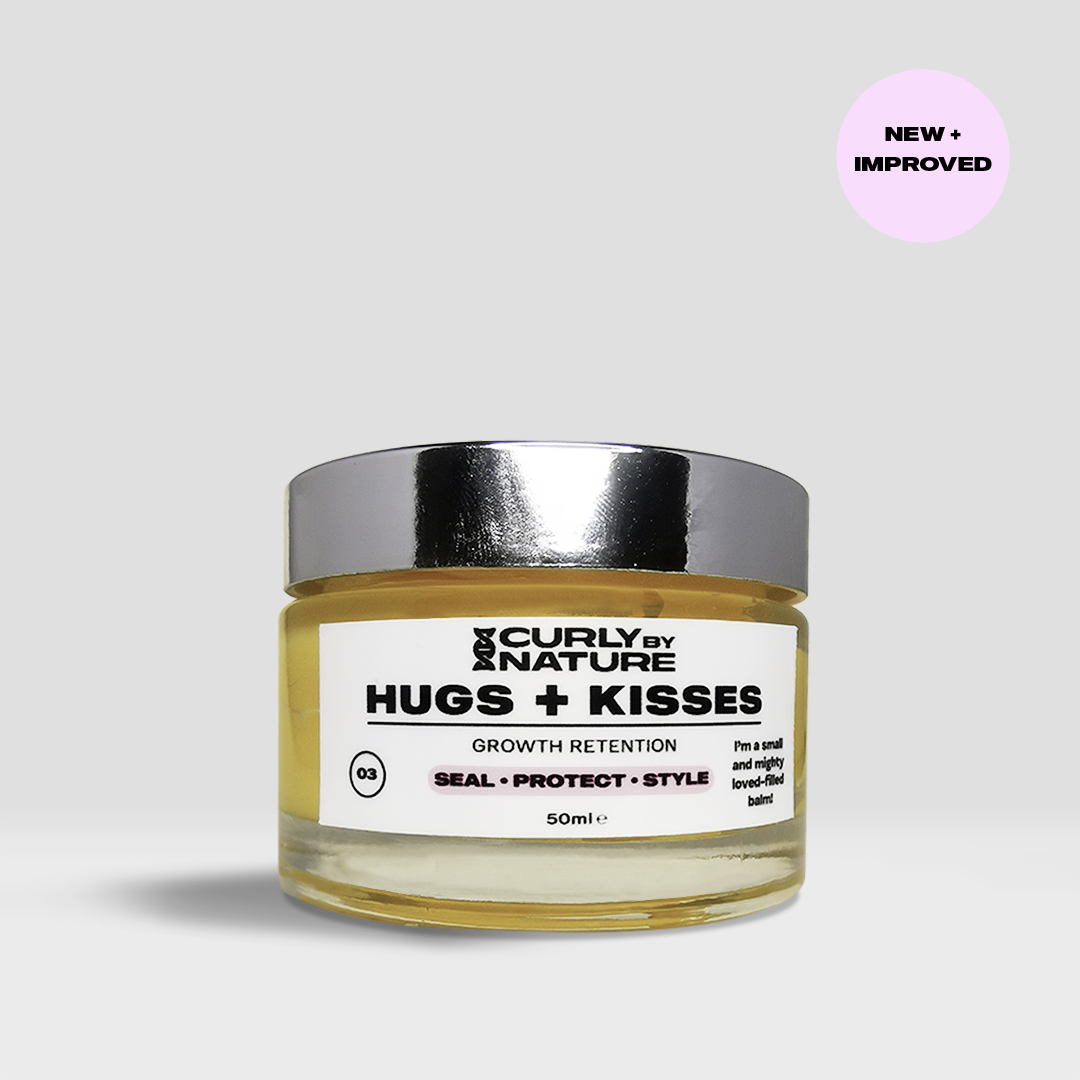 A clear jar with a label reading 'curly by nature HUGS + KISSES growth retention. Seal protect style.