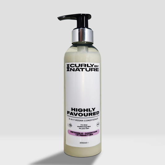 A bottle of HIGHLY FAVOURED conditioner by Curly by Nature, which is a vegan conditioner designed for curly hair.